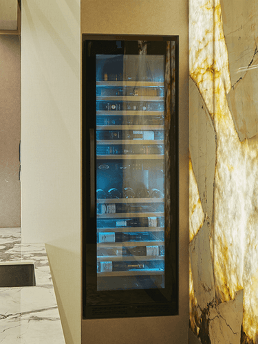 Jet Black Wine Fridge with icy blue lighting on placed in a marble shop
